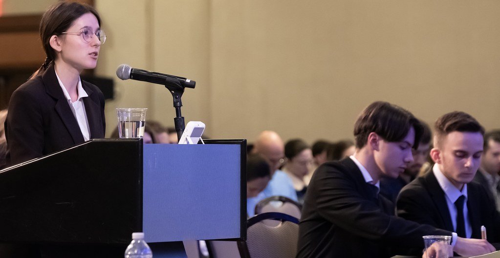 A student oralist argues from the podium during the Jessup 2025 White & Case International Rounds Final Round.