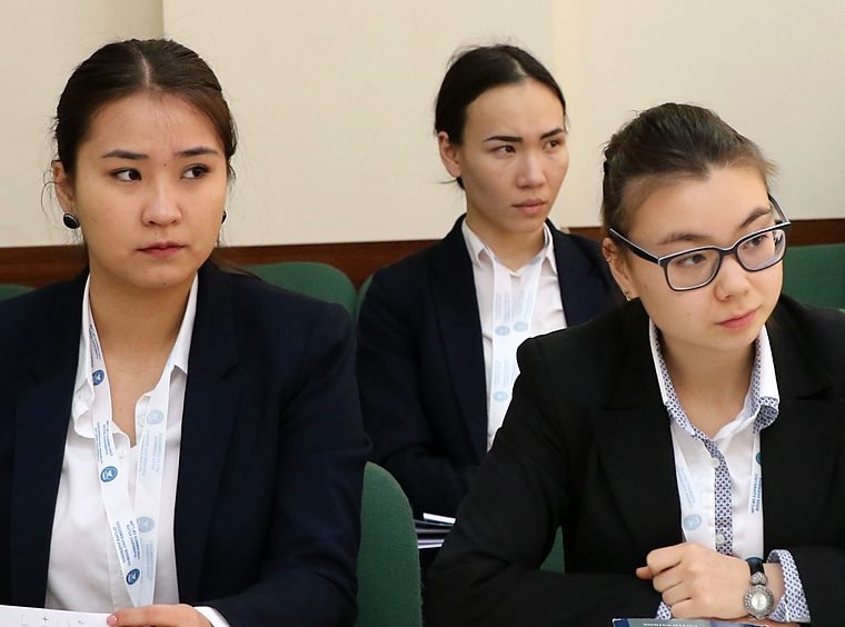 Students from one university team at the respondent table, listening closely to the argument.