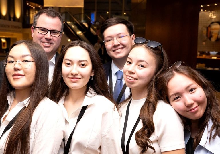 Six members of a Jessup team pose close together, smiling at the camera.