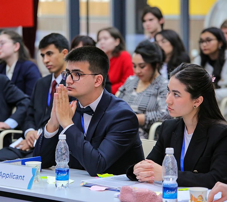 Two team members following a National Rounds session from the front row.