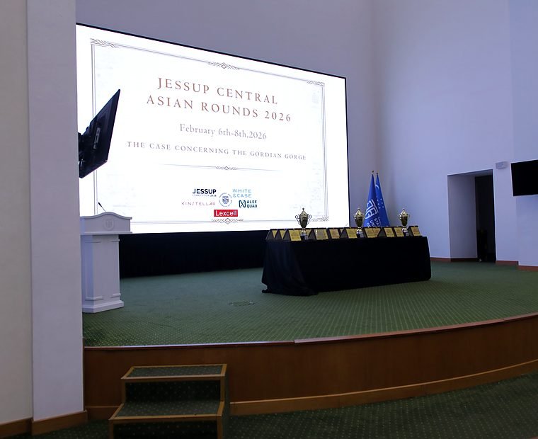 The stage and screen reading "Jessup Central Asian Rounds 2026, February 6th-8th 2026" in the venue hall.